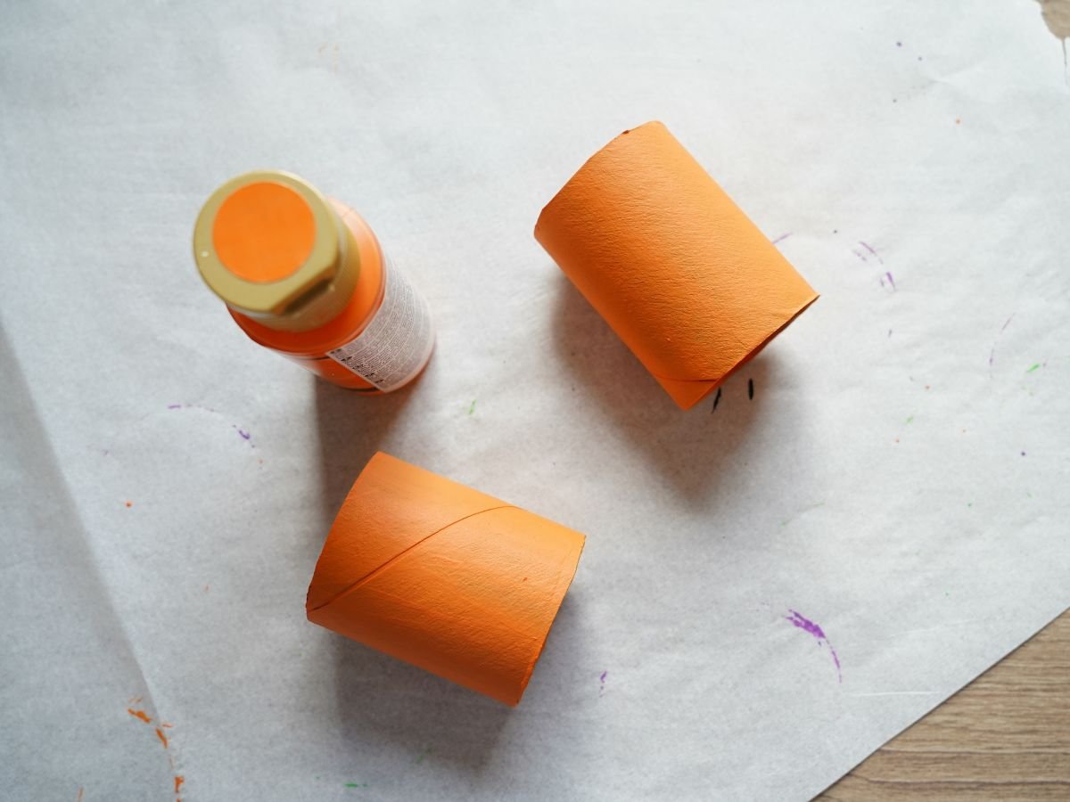 toilet paper roll painted orange and cut in half with paint
