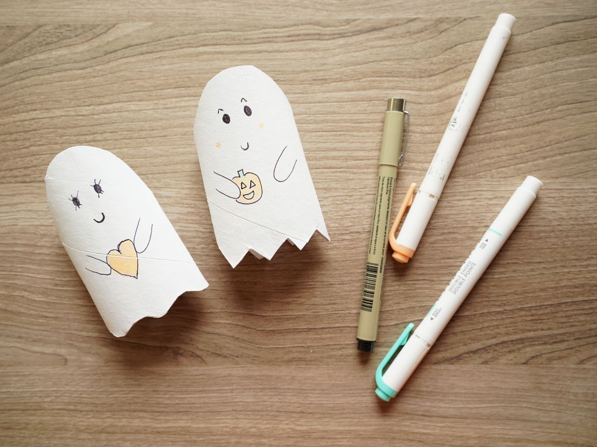 toilet roll ghosts with faces and arms drawn on with black pen and highlighters