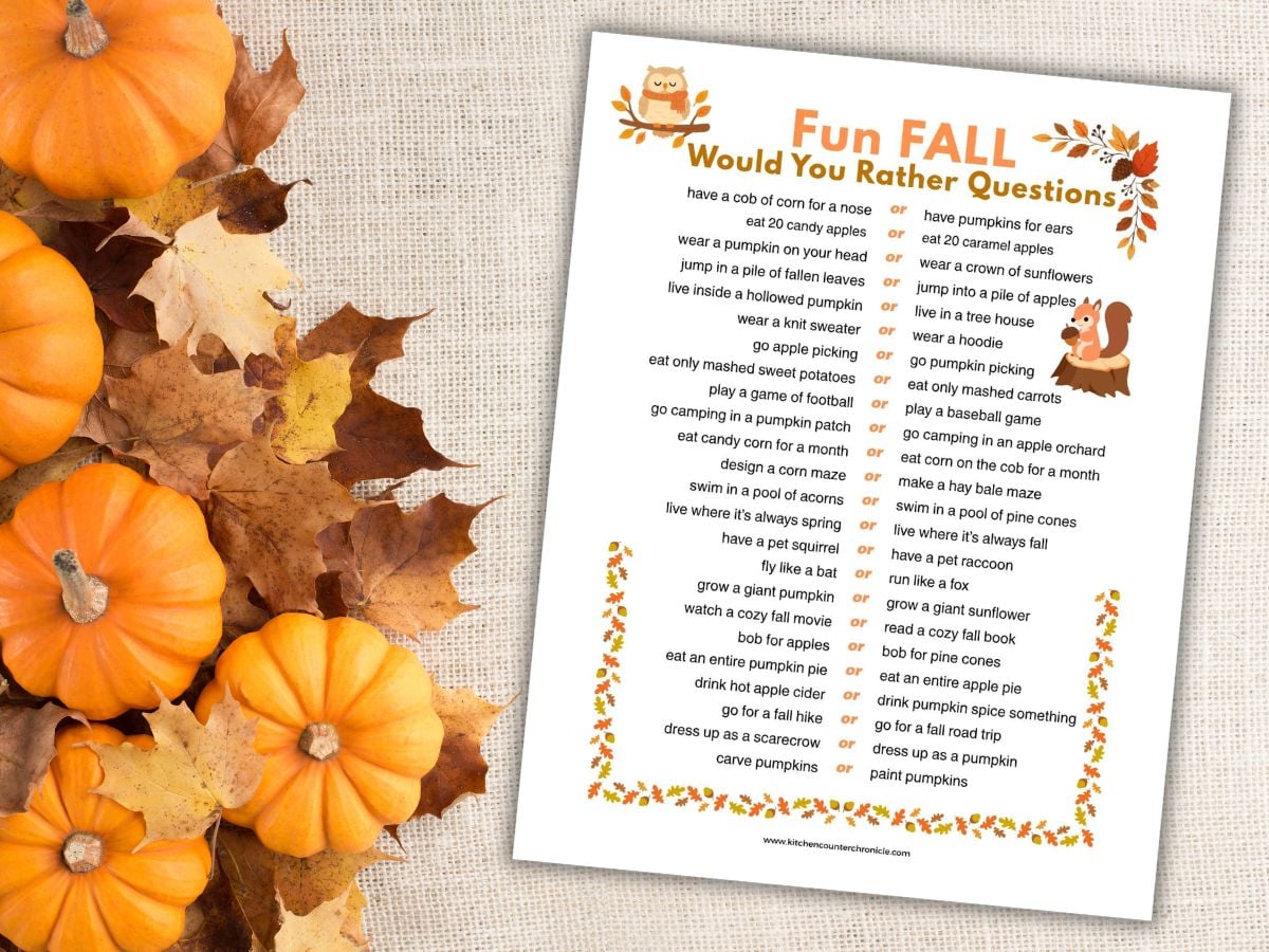 pile of pumpkins and leaves with a print out of fall would you rather questions for kids