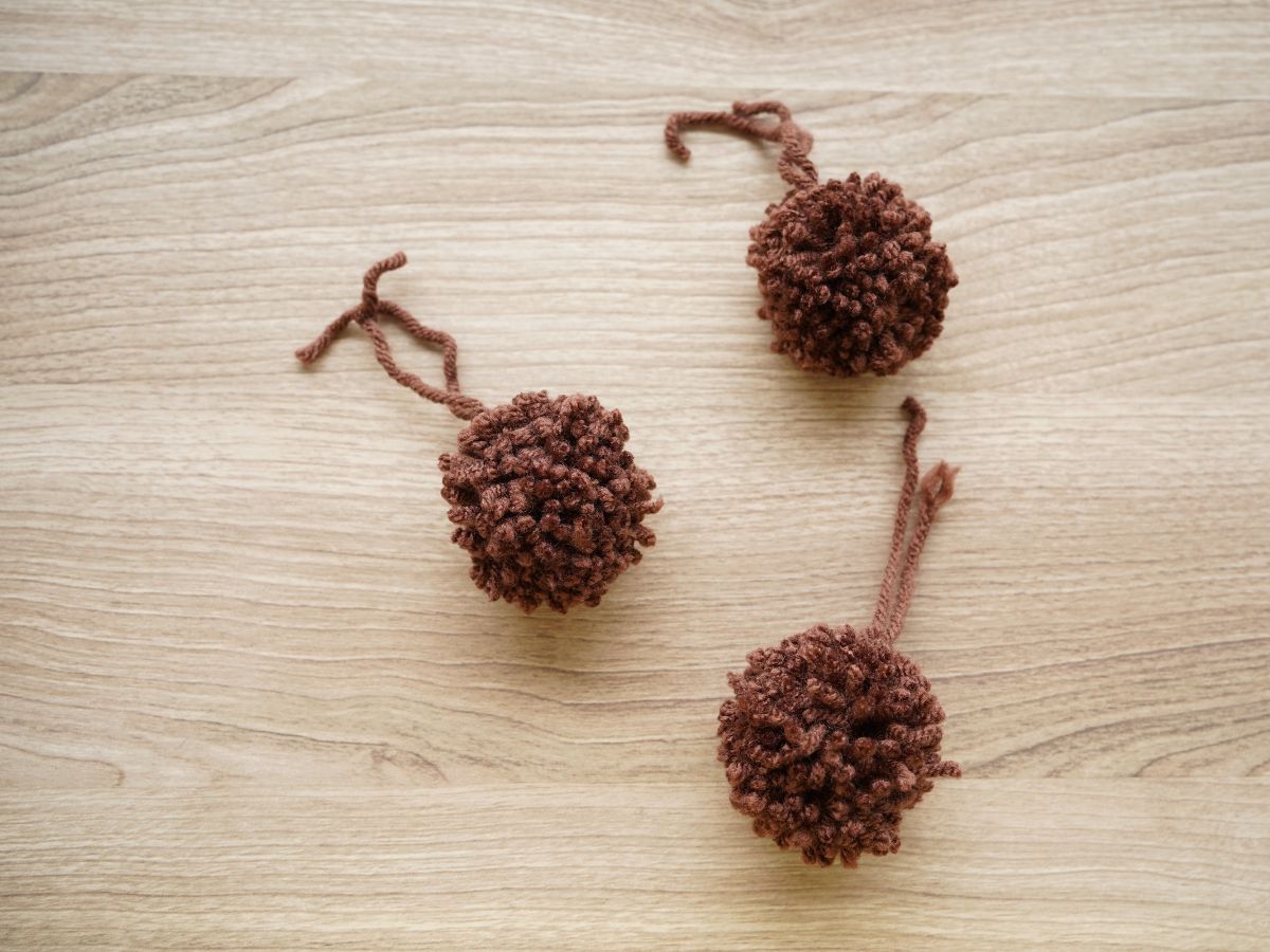 3 finished brown pom poms for reindeer Christmas ornaments