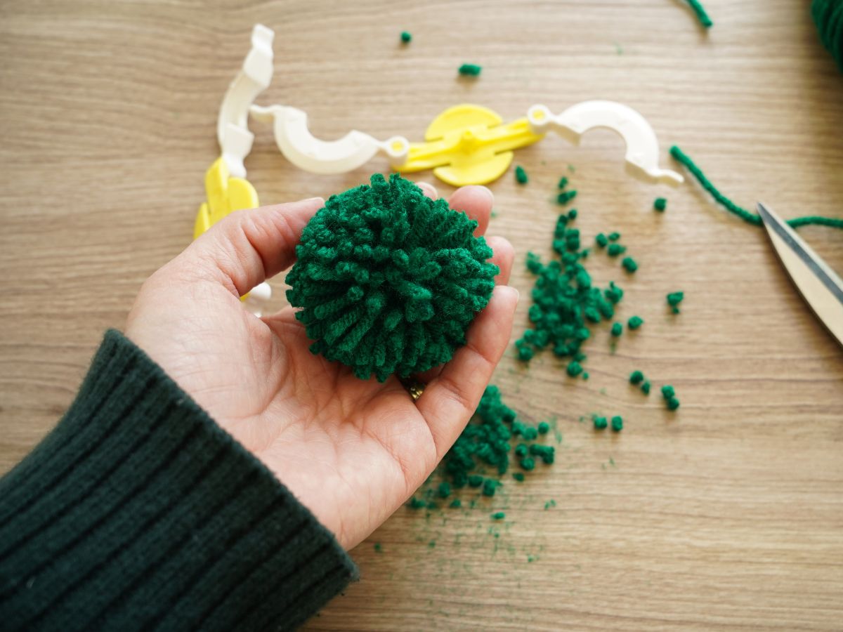 diy green pom pom in woman's hand