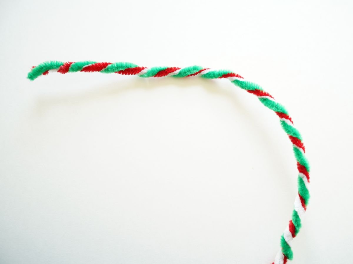green, white, and red pipe cleaners twisted into one pipe cleaner