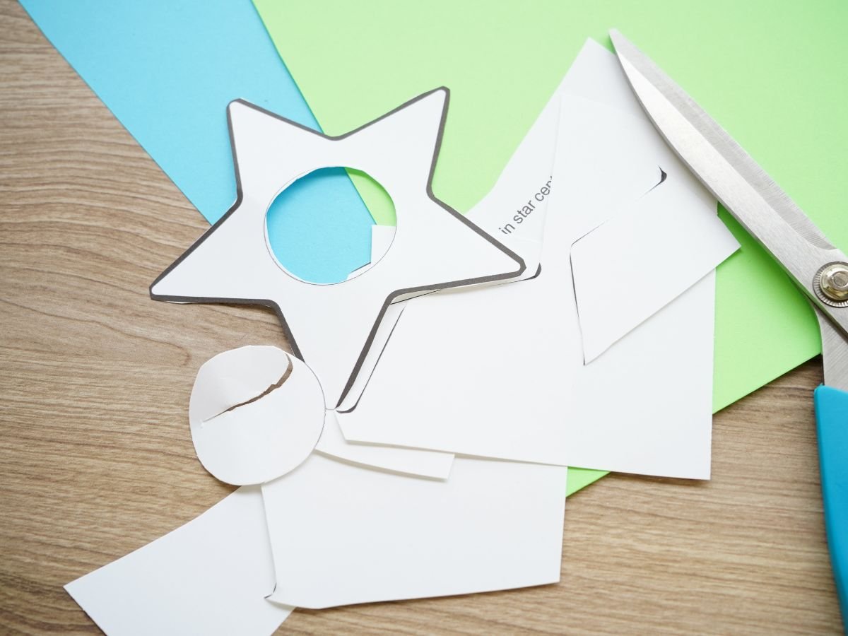 paper star template cut out with pair of scissors on table