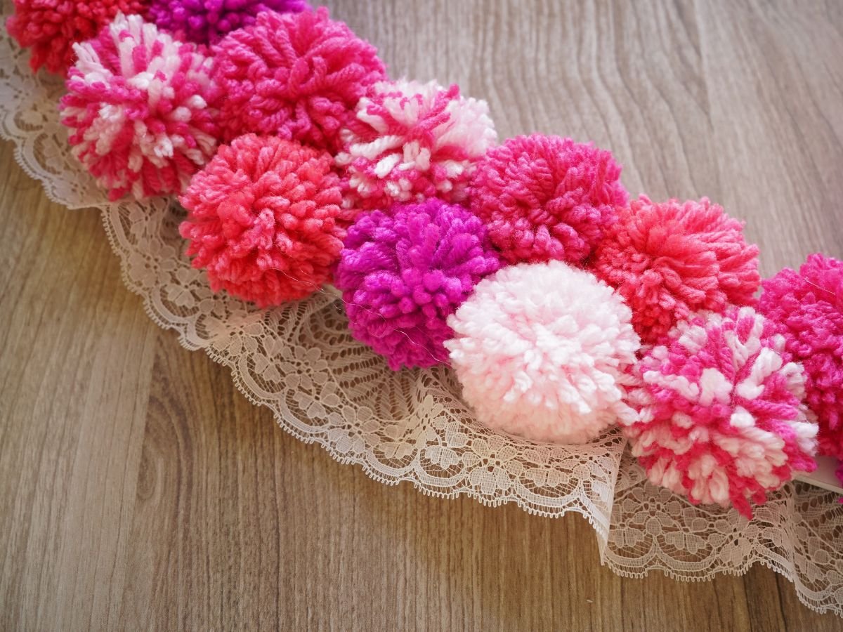 close up of lace trim and pom poms