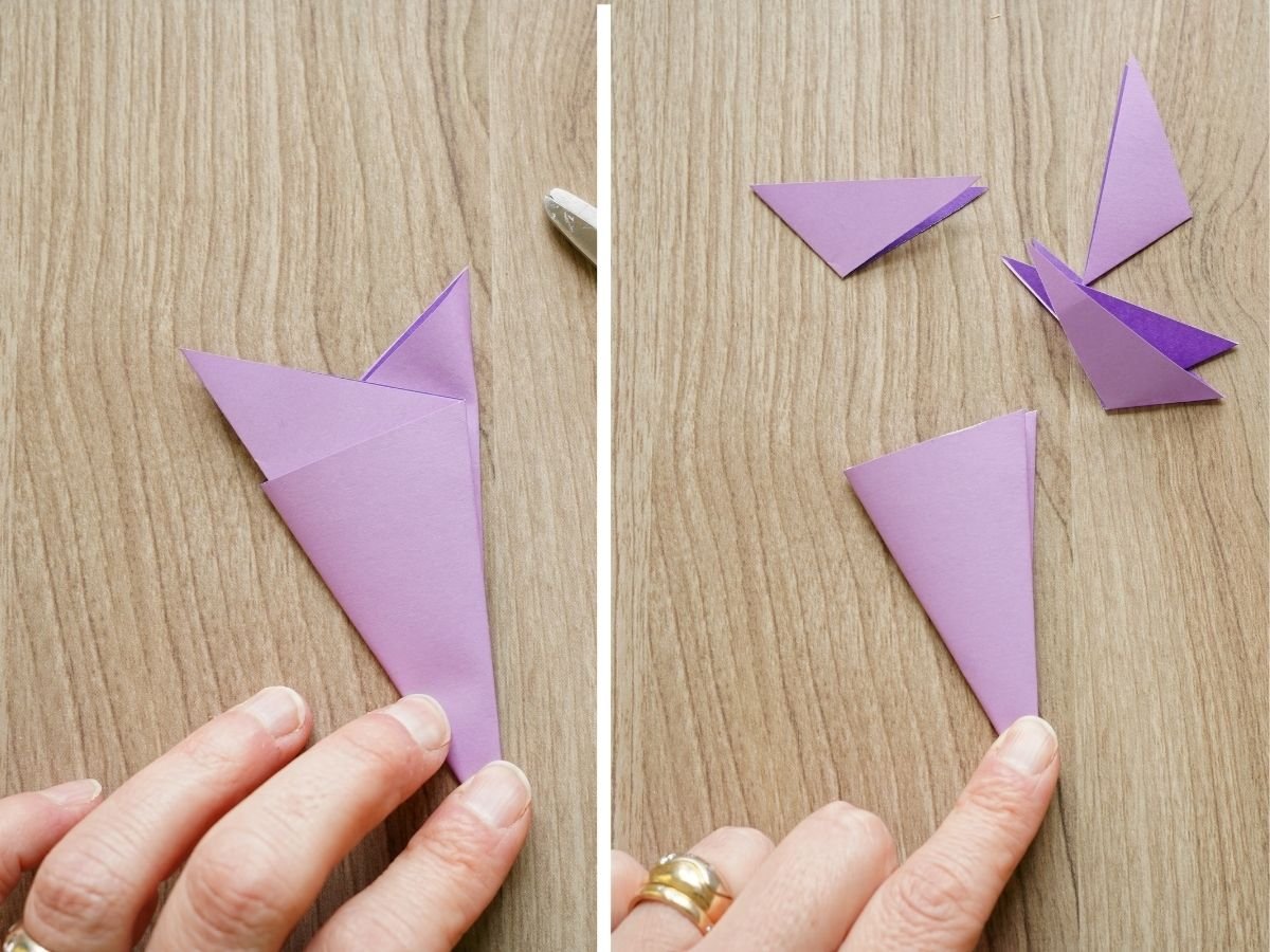 origami paper folded into snowflake thirds with tail ends trimmed off