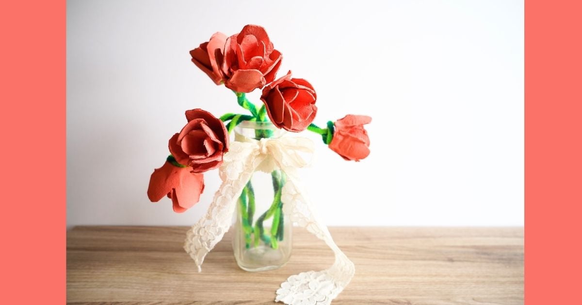 diy egg carton roses in a vase with lace bow tied around the vase