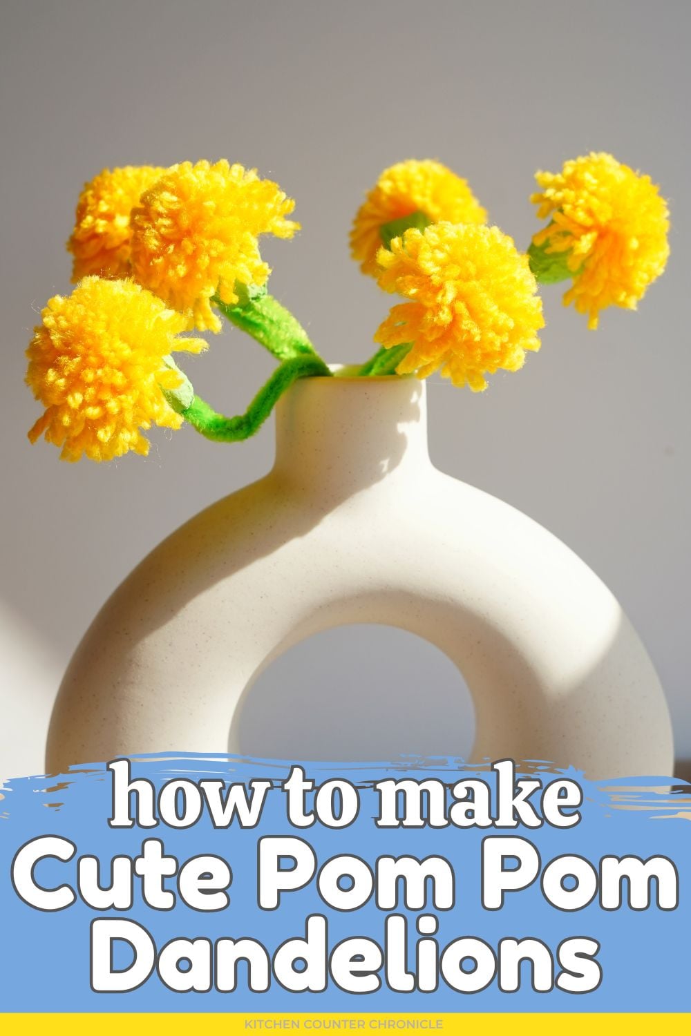 white vase filled with bouquet of pom pom dandelions with title how to make cute pom pom dandelion flower craft