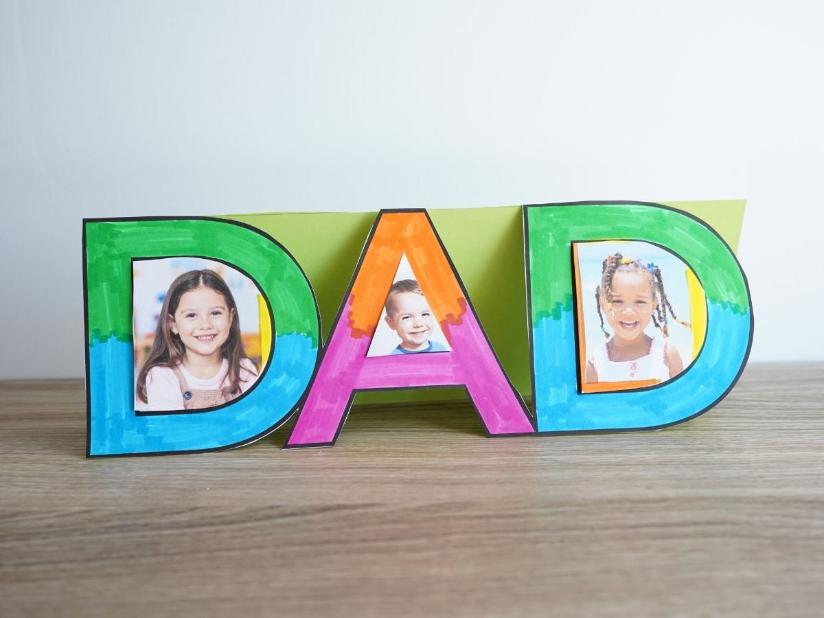 DAD picture frame sitting on table with pictures of kids inside