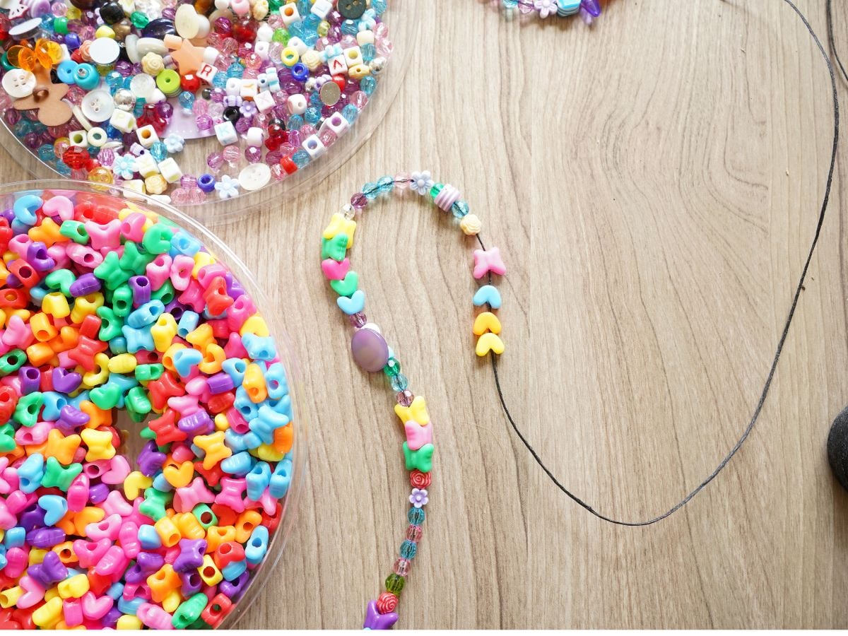 colorful beads threaded onto string of waxed linen