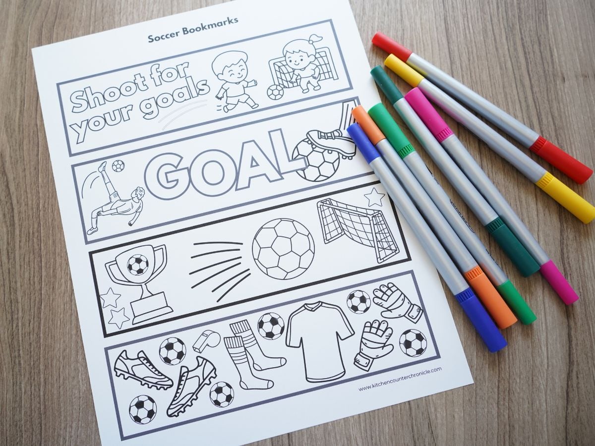 colorful markers beside a print out of our soccer bookmarks that haven't been colored