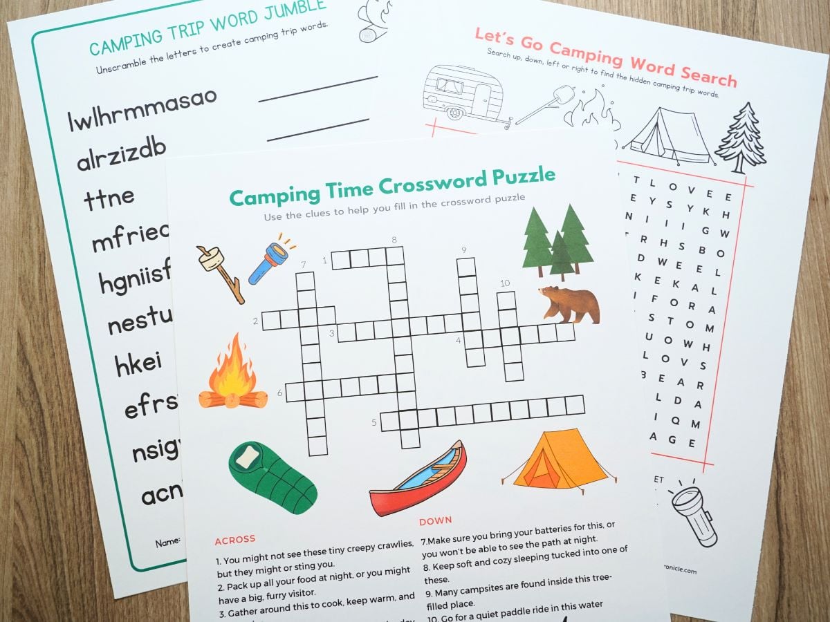 print out of all three camping trip word games in a pile on a table