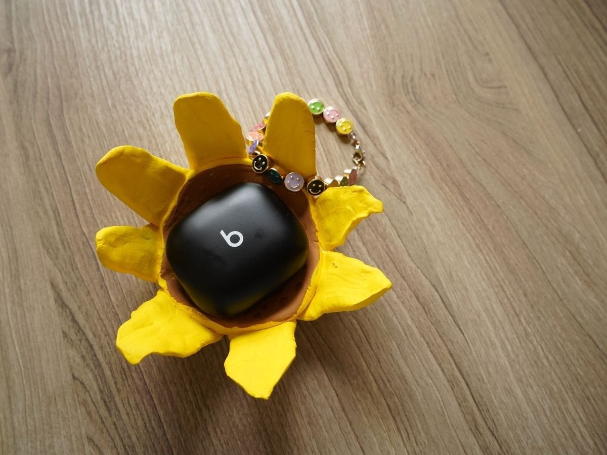 beats headphones case inside a diy air dry clay sunflower pinch pot