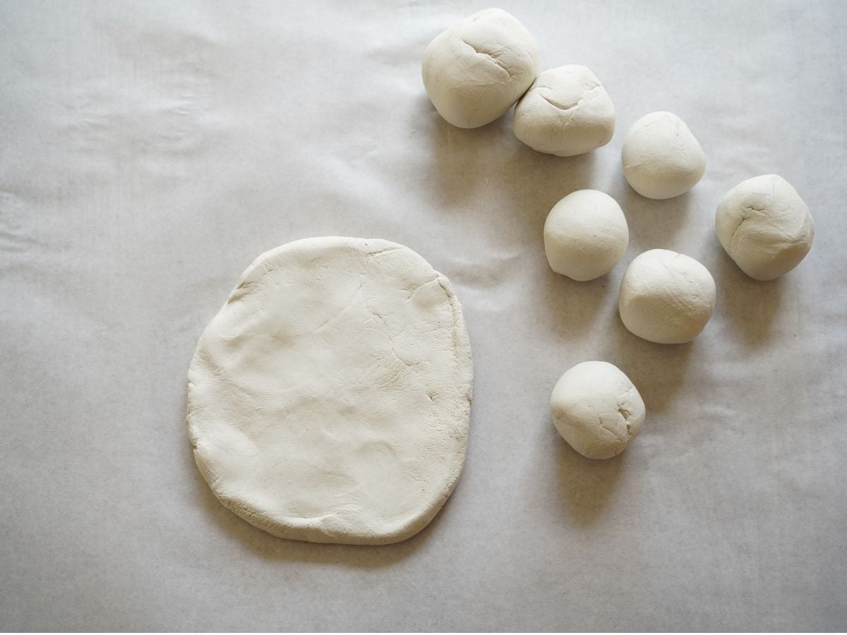 diy clay bowl bottom with balls of clay for flower petals
