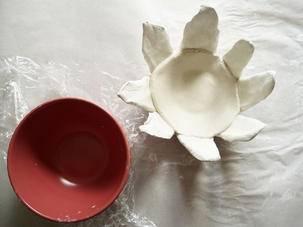 dried sunflower clay pot sitting beside small bowl