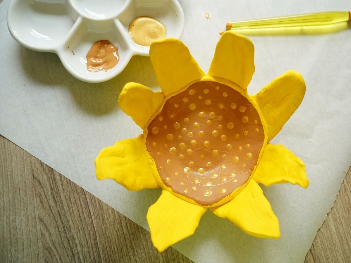 gold painted polka dots inside of sunflower shaped clay pot craft