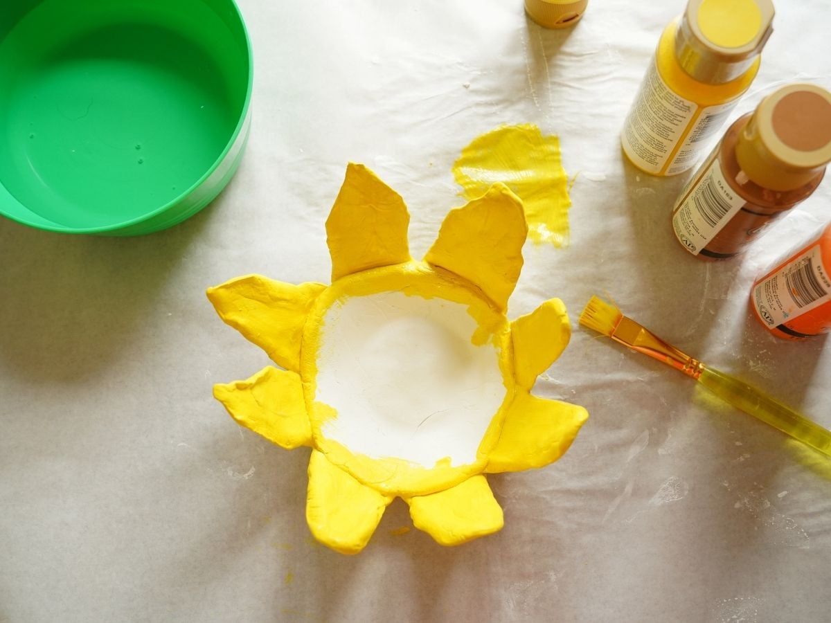 sunflower clay pot petals painted yellow and sitting to dry