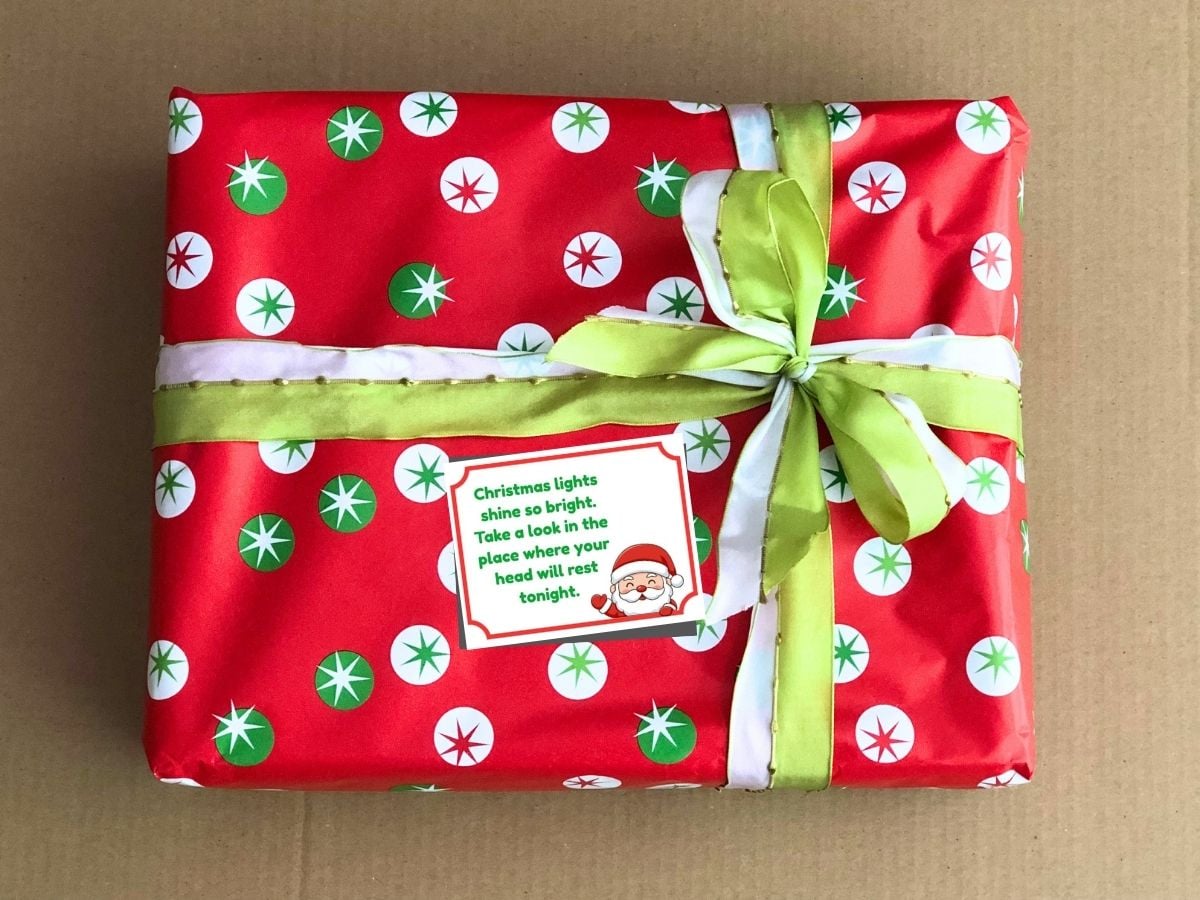 final christmas scavenger hunt clue on top of a wrapped present